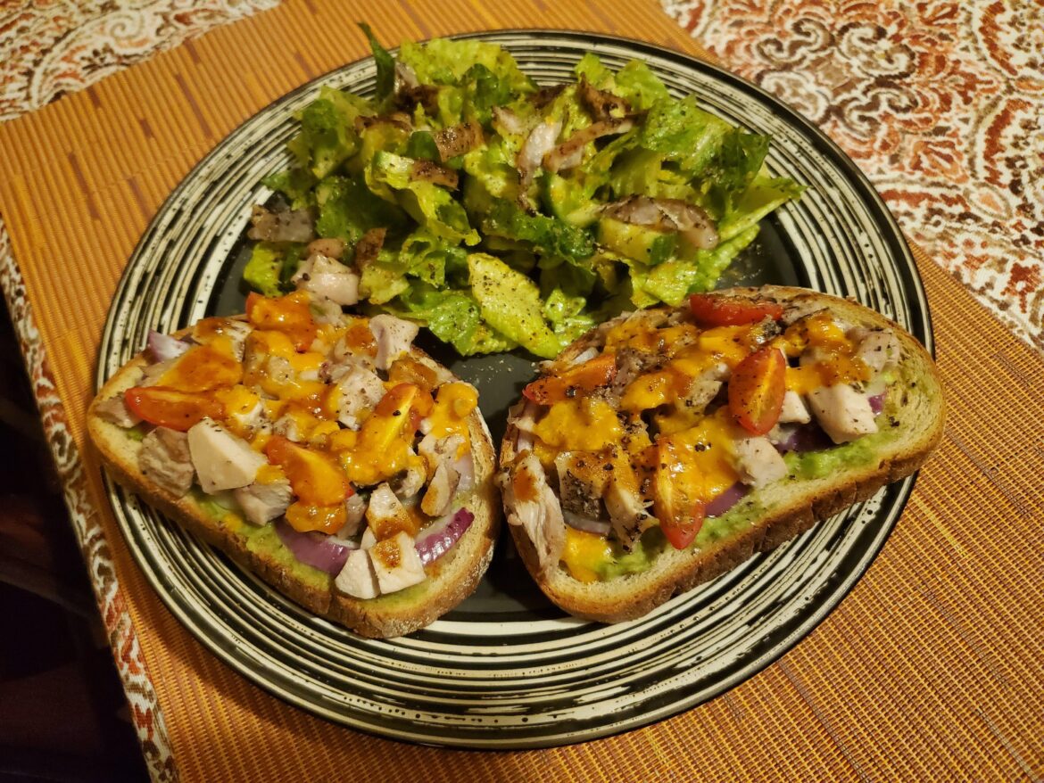 Open-faced chicken sandwich and salad