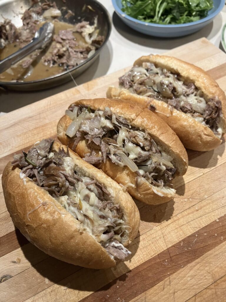 Braised lamb shank French dip with sharp provolone and lemon dressed arugula.   I spilled the entire thing of the jus so the dip portion was missing 🤦‍♂️