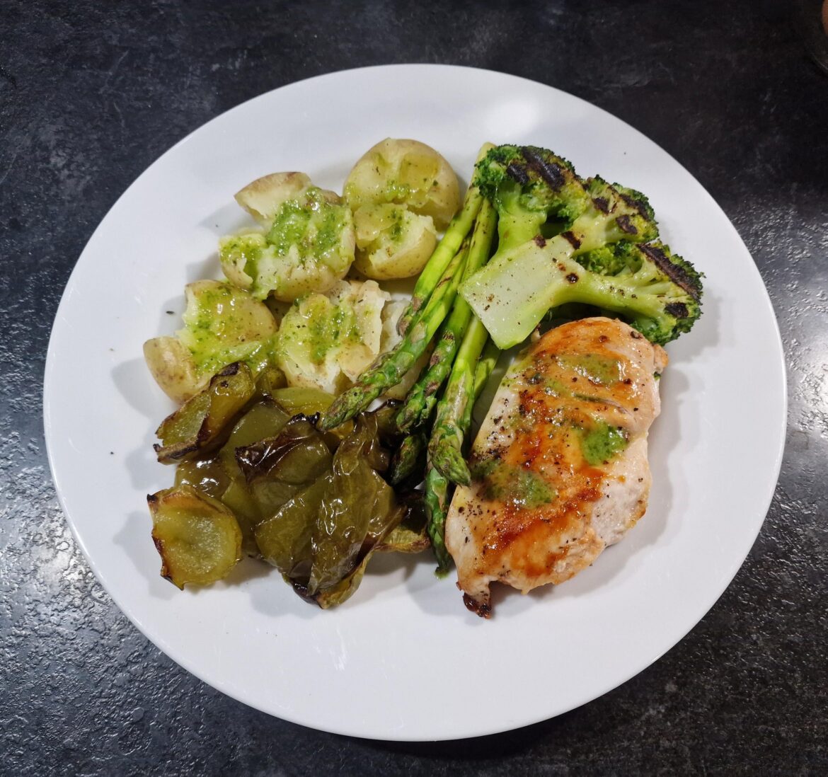 Pan roasted chicken, crushed baby potatoes, roasted green peppers, broccoli, asparagus, garlic and parsley butter on the tatties.