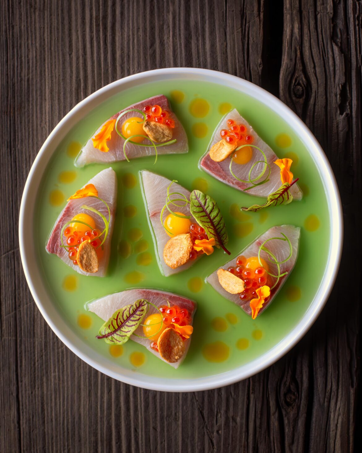 Hamachi Crudo with Cucumber Yuzu Ponzu, Chili Sesame Oil, Mango Gel, Salmon Roe, Fried Garlic Chips, and Green Onion