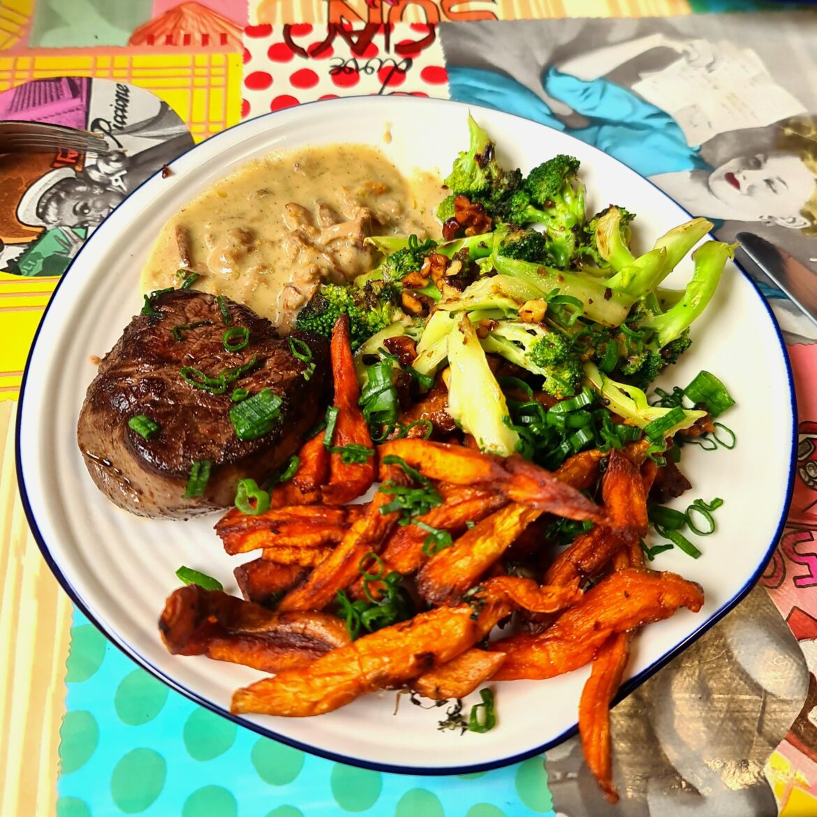 Sous vide fillet mignon served with crispy sweet potato fries, charred broccoli with walnuts and chanterelle Gorgonzola sauce