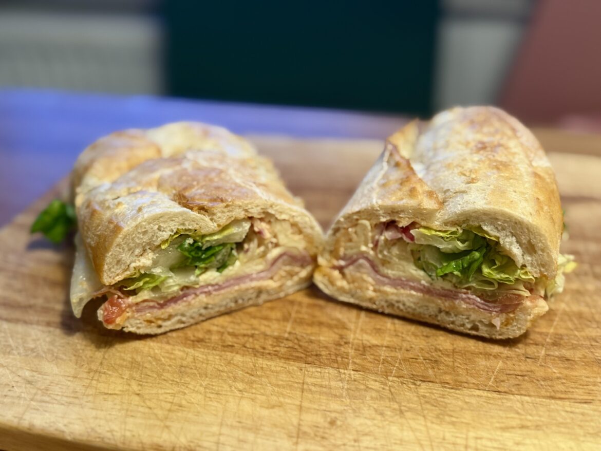 Hamburg style croque with juniper crust ham, melted cheddar, romaine, purple tomato, red onions and homemade garlic dressing