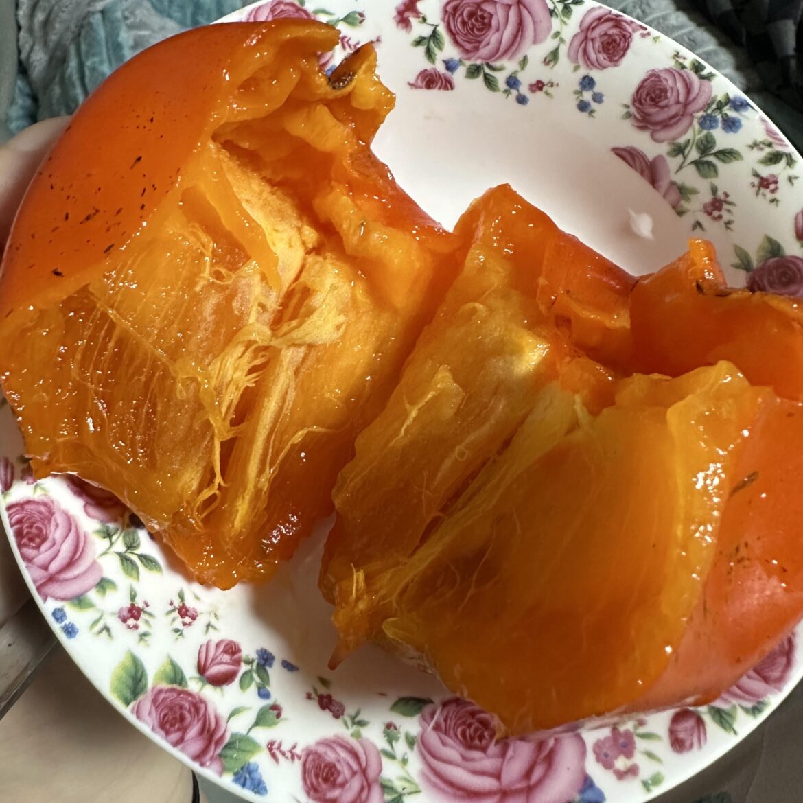 Eating a persimmon! It's super sweet and also healthy.