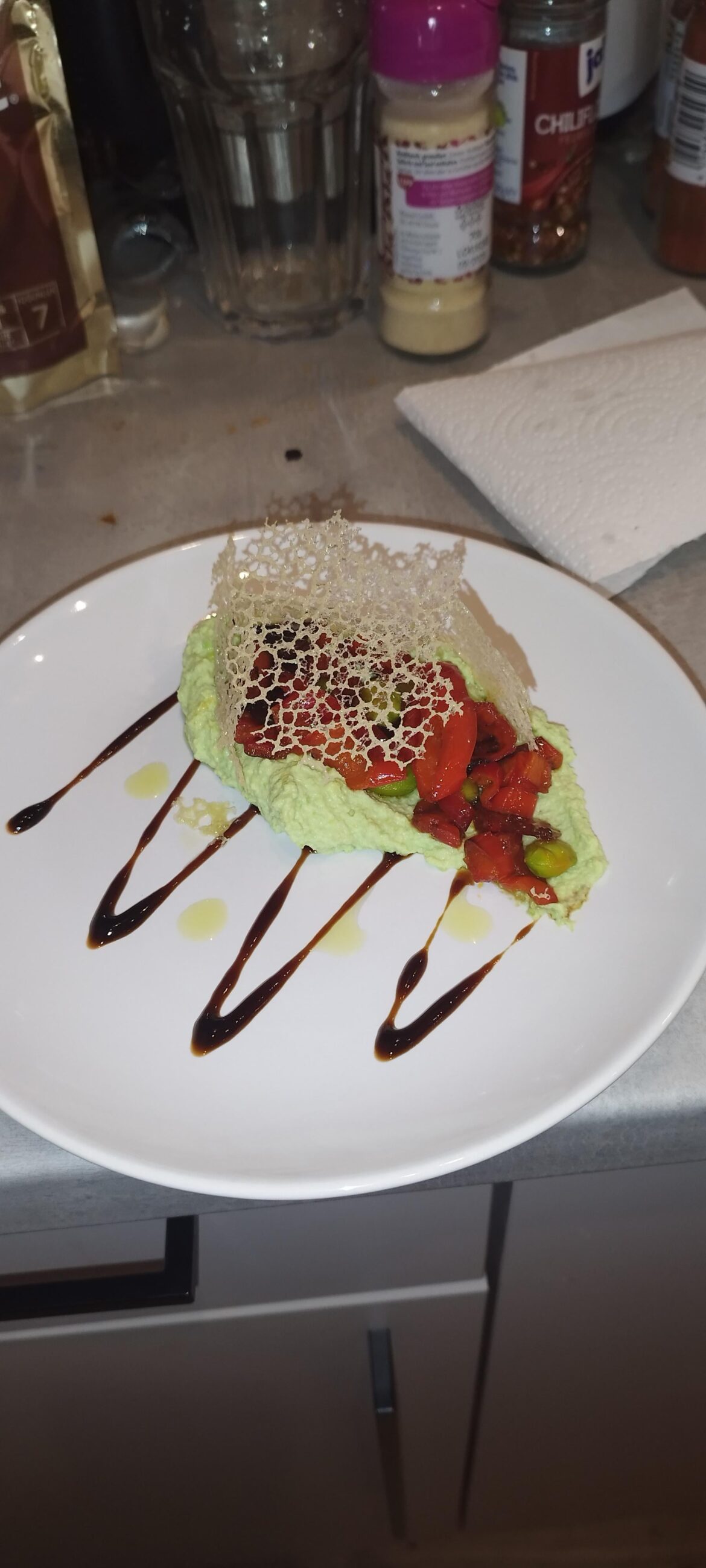 Edamer Bean purée, topped with chilli paprika slices on a balsamic vinegar bed