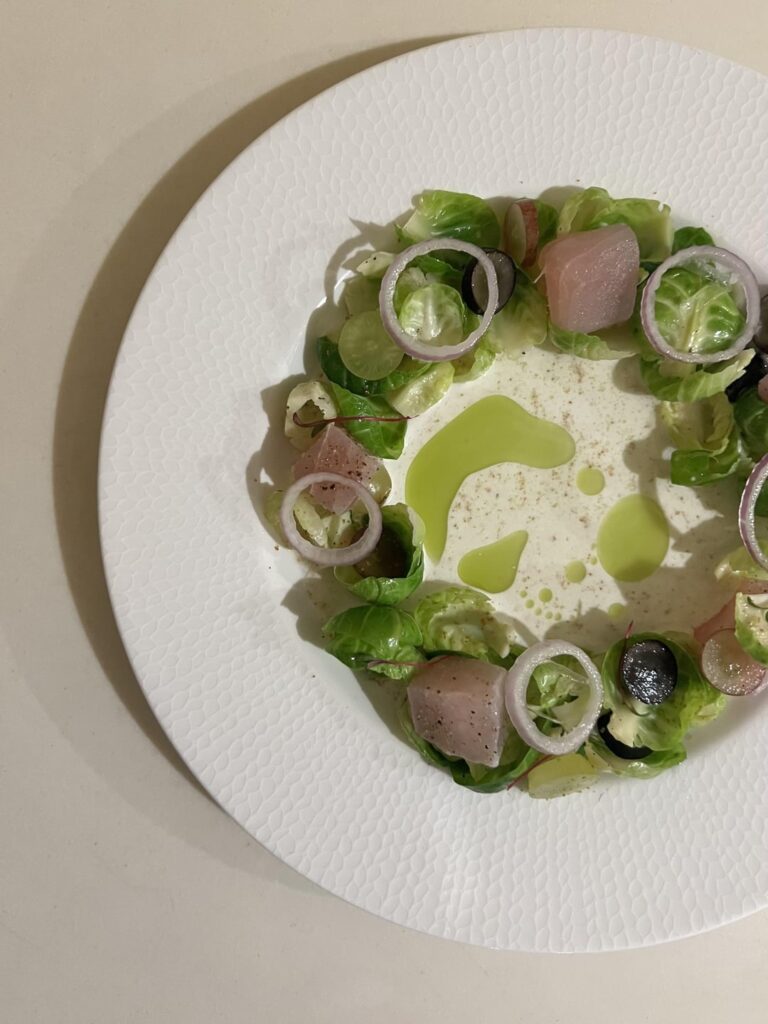 Cured Wahoo with Brussel Sprout Petals, Grapes and Ajoblanco, finished with Grated Homemade Bottarga fresh from the Wahoo itself.