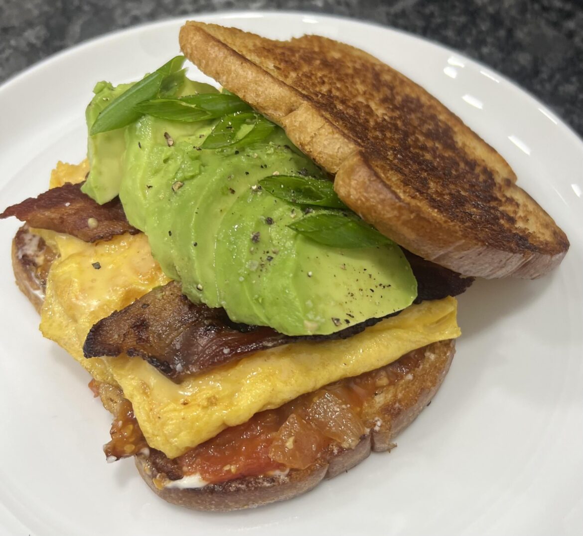 Tomato bacon jam breakfast sandwich with some green onions to top 🚀