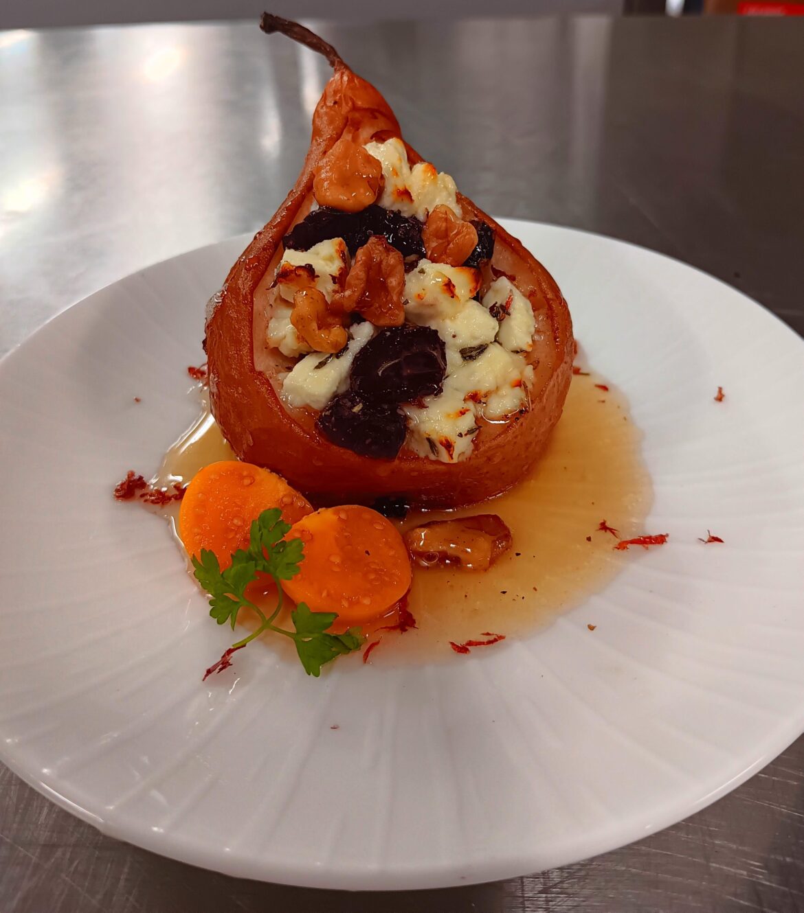 Pear stuffed W/ feta, dried cranberry, thyme with walnuts and a honey drizzle.
