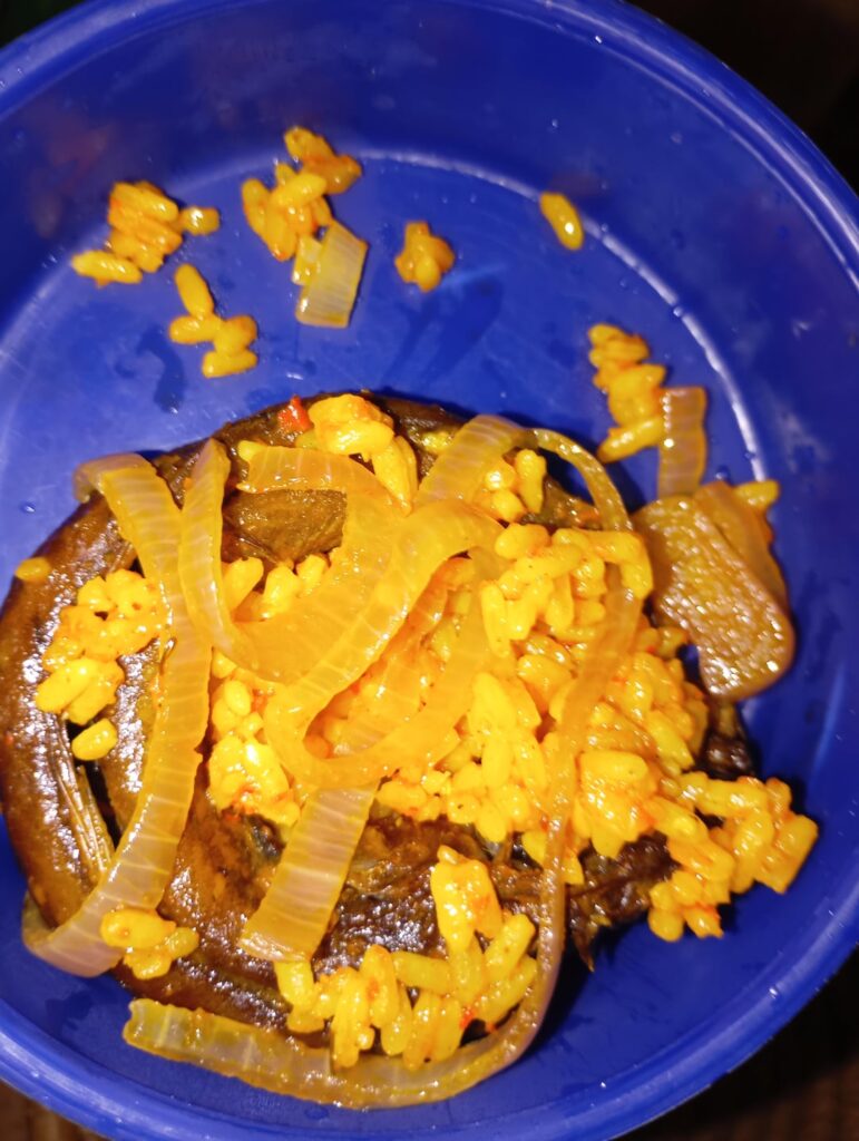 Breakfast. Onions steamed in Nigerian jollof rice.