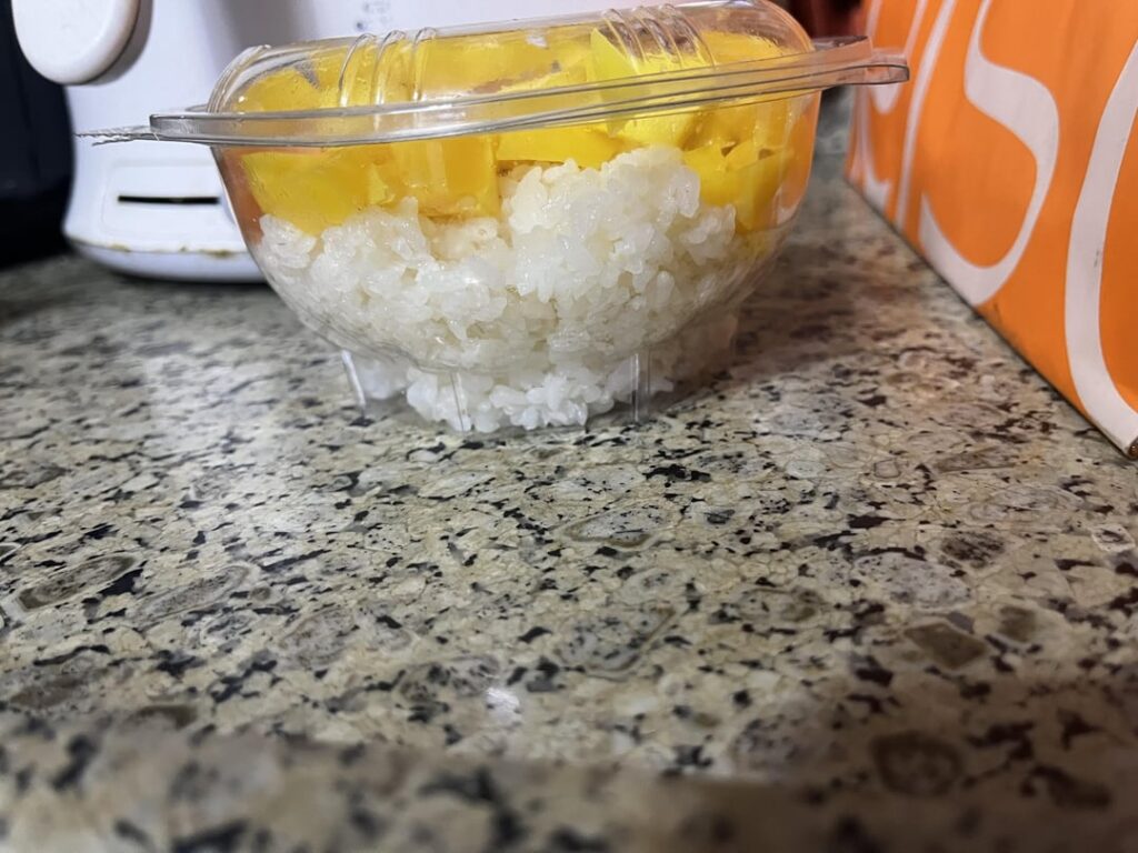 poke bowl with mangoes, salmon, and crispy onions