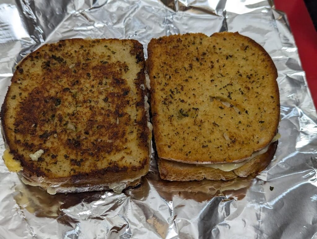 First time making grilled cheese. Used left over garlic butter (with coriander and hot pickled chillies), white sourdough bread and mature cheddar. Left was made on a frying pan and right was in the air fryer. Air fryer was better.