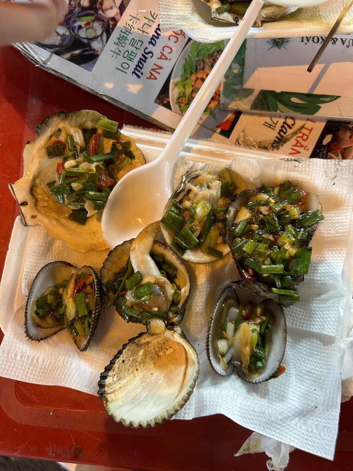 A variety of grilled clams in Vietnam! No clue what the sauce was but it was very good
