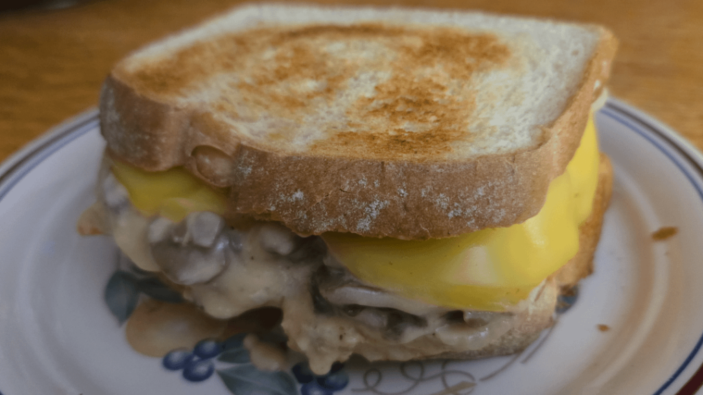 Porkchop and mushroom gravy sandwhich with smoked gouda.
