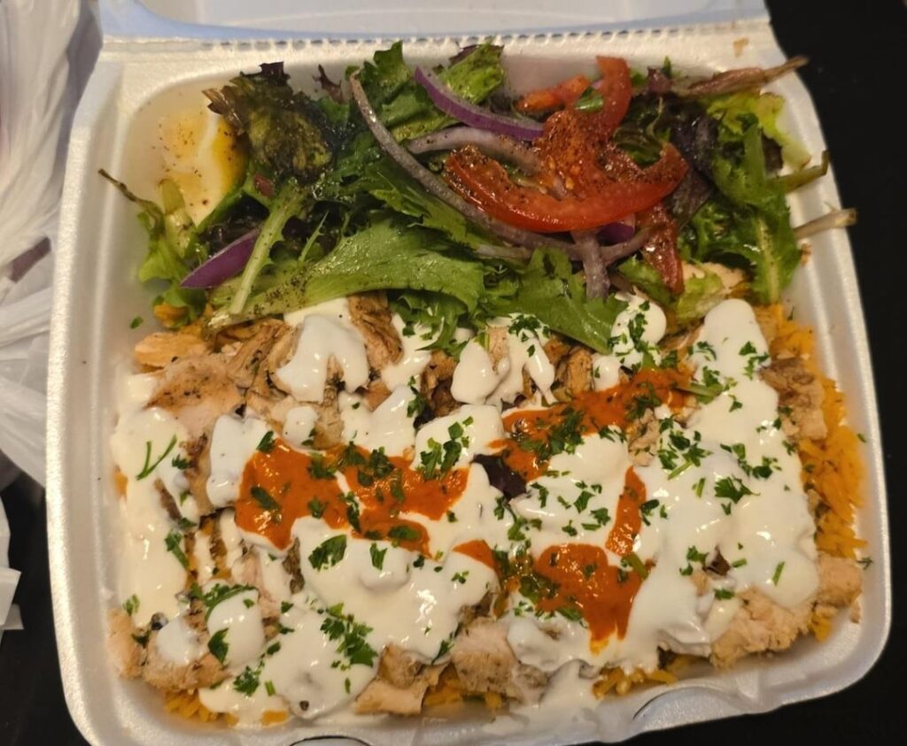 Shicken chwarma, garlic and harissa sauce over rice ✨️ with salad ✨️