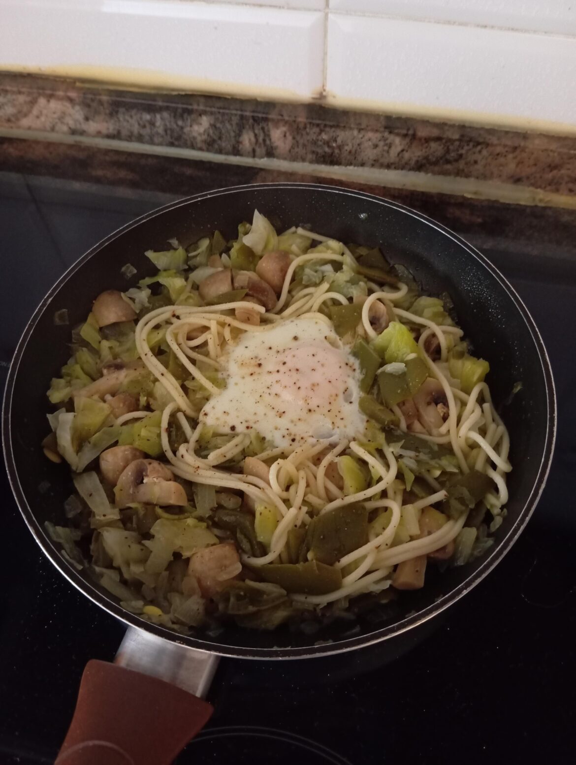 Today's lunch: mushrooms with day old vegetables, day old spaghetti and of course, an egg
