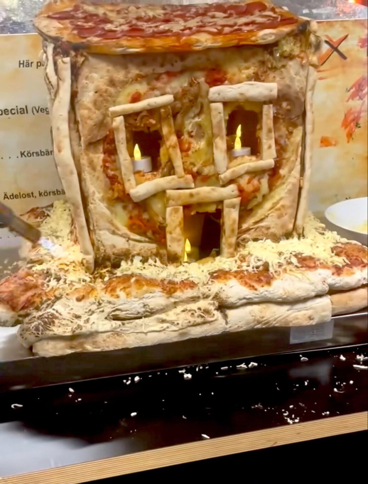 Swedish pizzeria makes a gingerbread house out of Pizza.