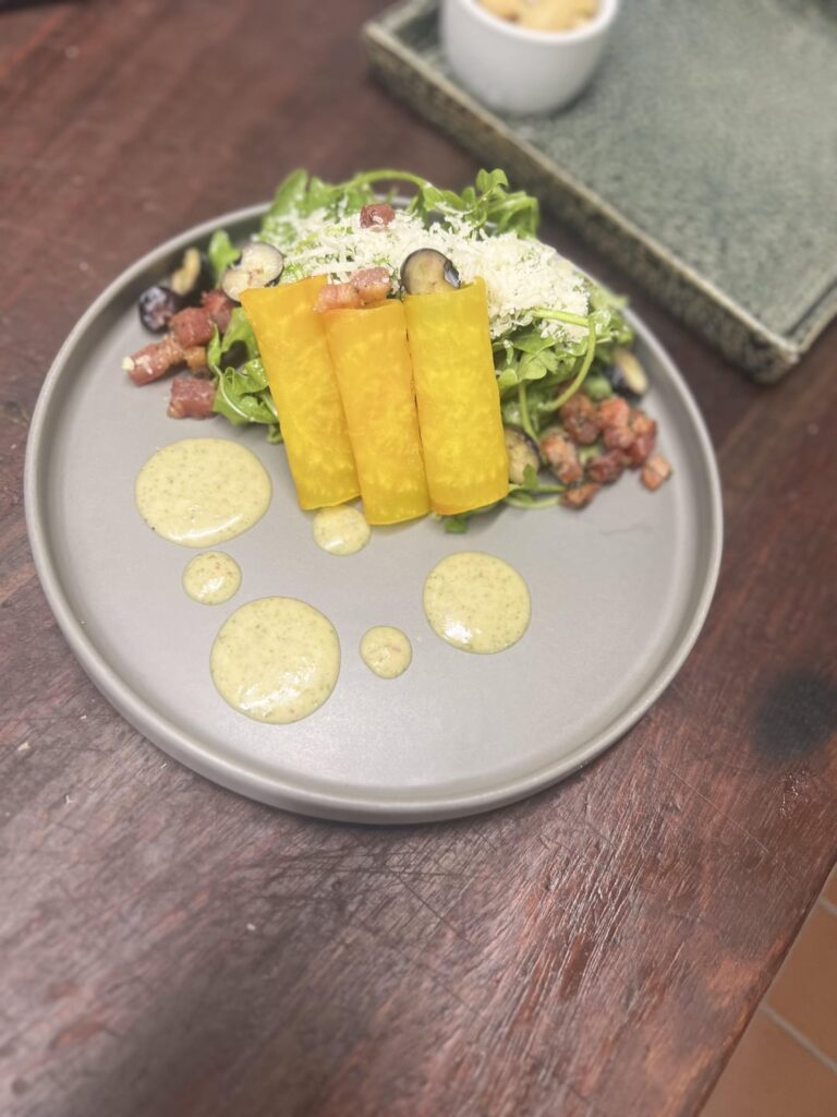 Arugula, pepita vinaigrette, candied pancetta, blueberries, golden beets, manchego cheese