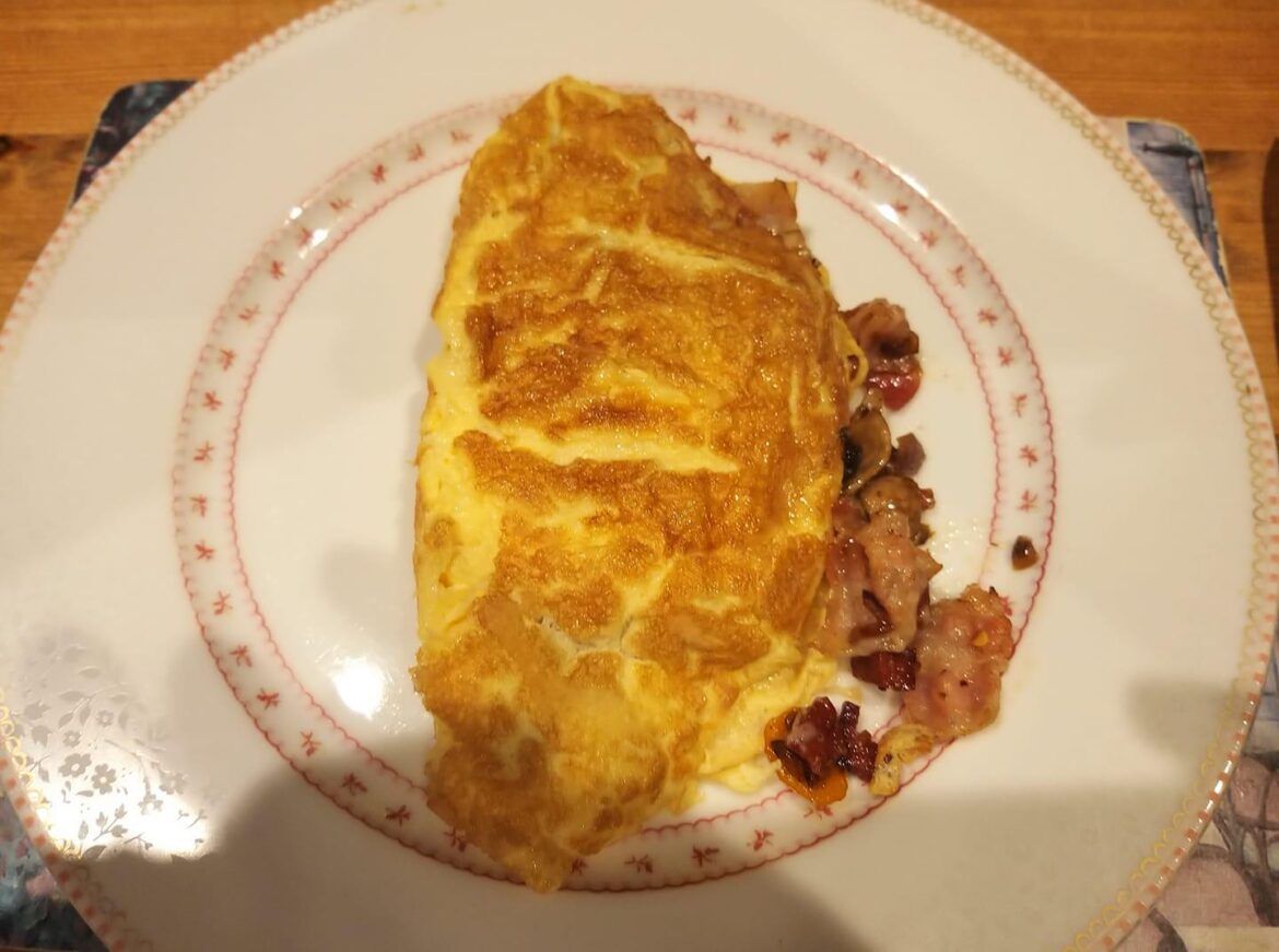 Egg omelette with chorizo, yellow peppers, mushrooms, and red onions topped with cheese