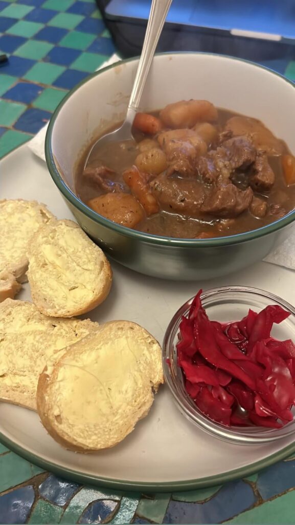 Bowl of scouse (with buttered crusty bread and pickled red cabbage)