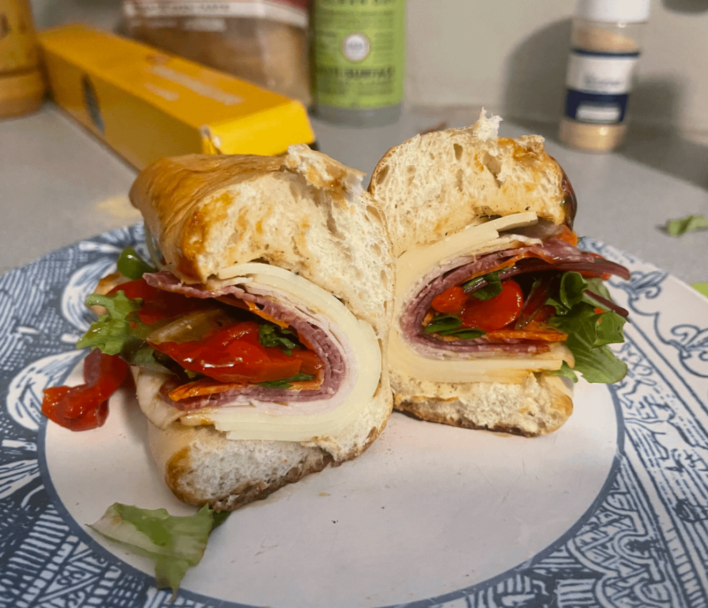 My first grinder. Mozzarella, oil and vinegar, balsamic glaze, genoa, pepperoni, turkey, roasted peppers, greens, on baguette