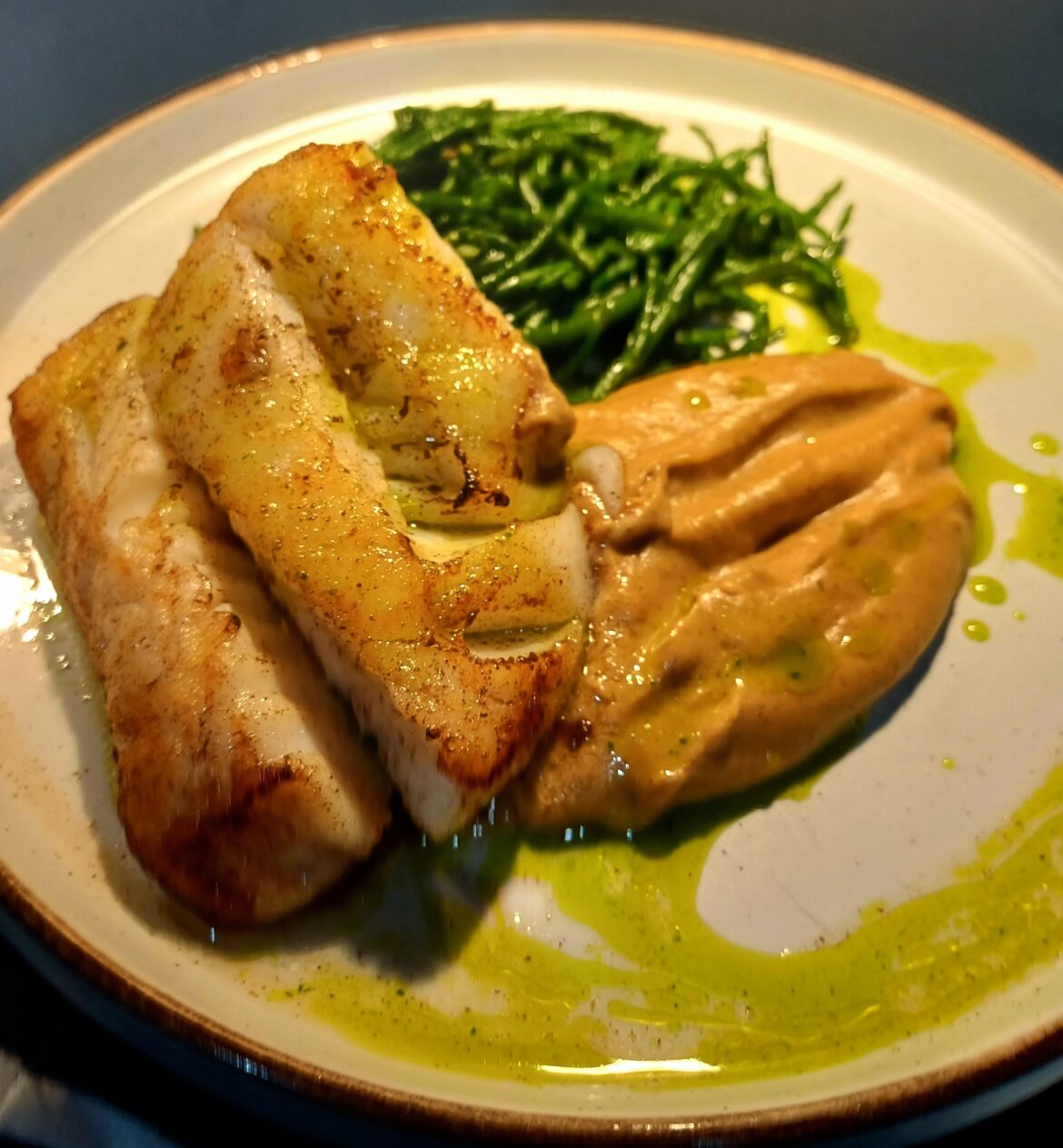 Pan fried cod loin, roasted cauliflower puree, sauted samphire and parsley oil