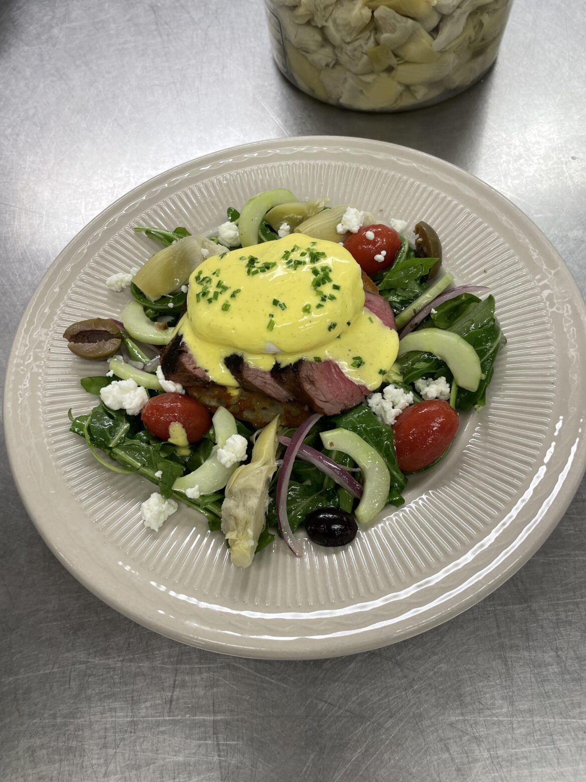 Eggs benedict w/lamb on a Greek cucumber salad