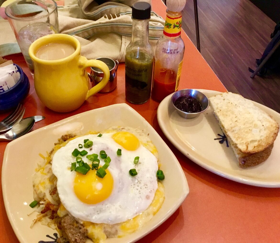 Hash Browns, sausage gravy, sausage, and cheese with eggs on top