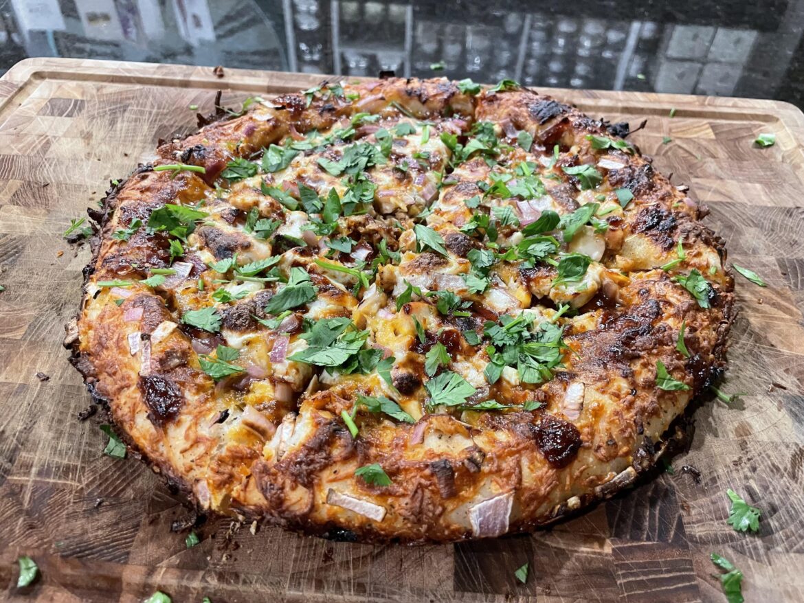 Cast iron style BBQ chicken stuffed crust pizza with Peruvian rotisserie chicken.