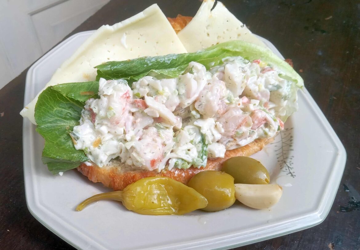 There is a butter croissant under this pile of home made seafood salad (50% krab and 25% each scallop and shrimp). With havarti cheese, Dukes lime mayo, and some fancy-ass romaine from Costco