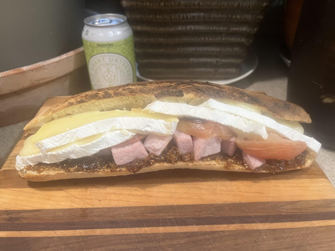 Ham and brie, with horseradish baked apples and fig jam sandwich, on a toasted baguette.
