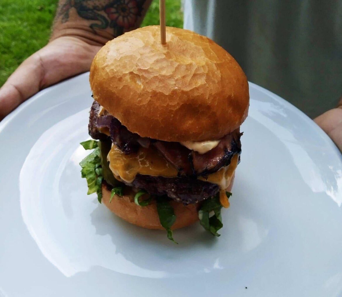 Hamburger with beef, English bacon, caramelized onions, basil dressing, salad and BBQ sauce. Prepared from Czech ingredients in the city of České Budějovice my friend Helen.