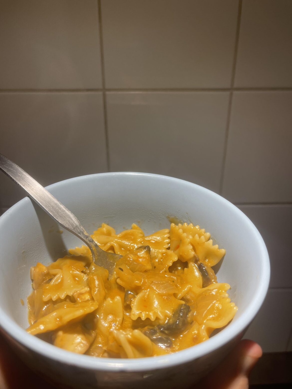 Pasta farfalle with mushrooms, onions, and pesto rosso