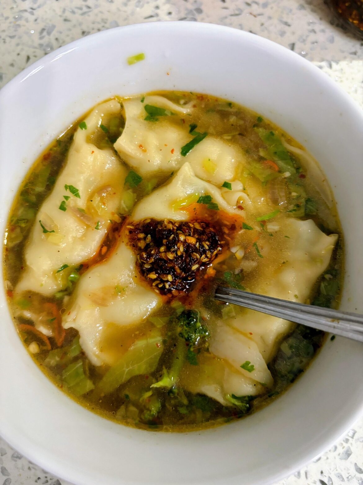 Dumpling Soup topped with homemade chili oil—the perfect comfort food to chase away the Sunday blues.