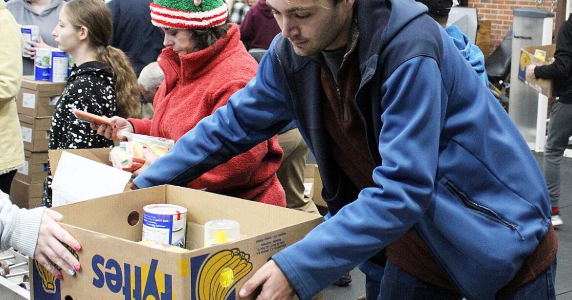 Volunteers pack boxes for Christmas food fund | News