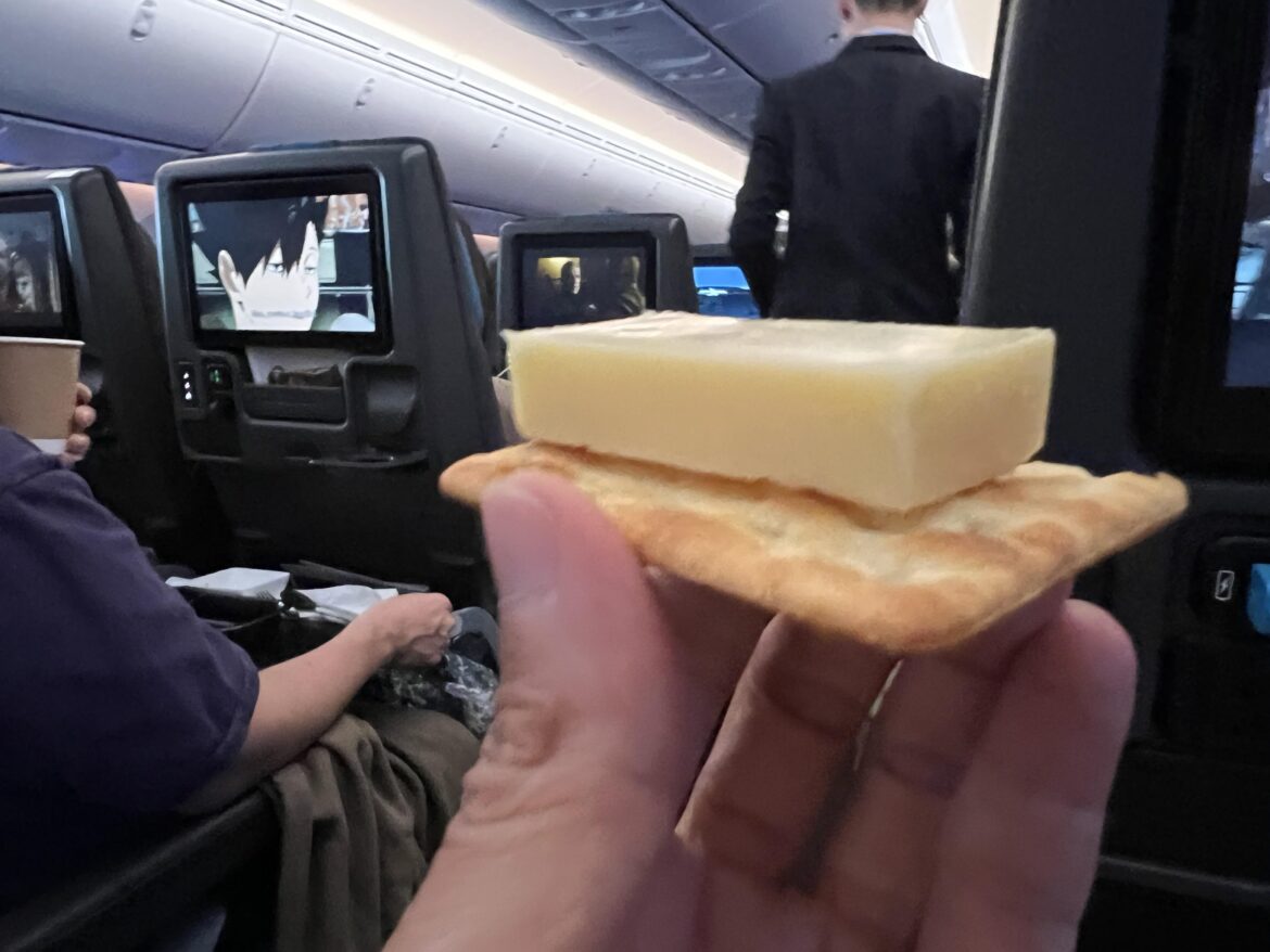currently having some australian cheddar whilst flying to osaka,  washed down with some white wine