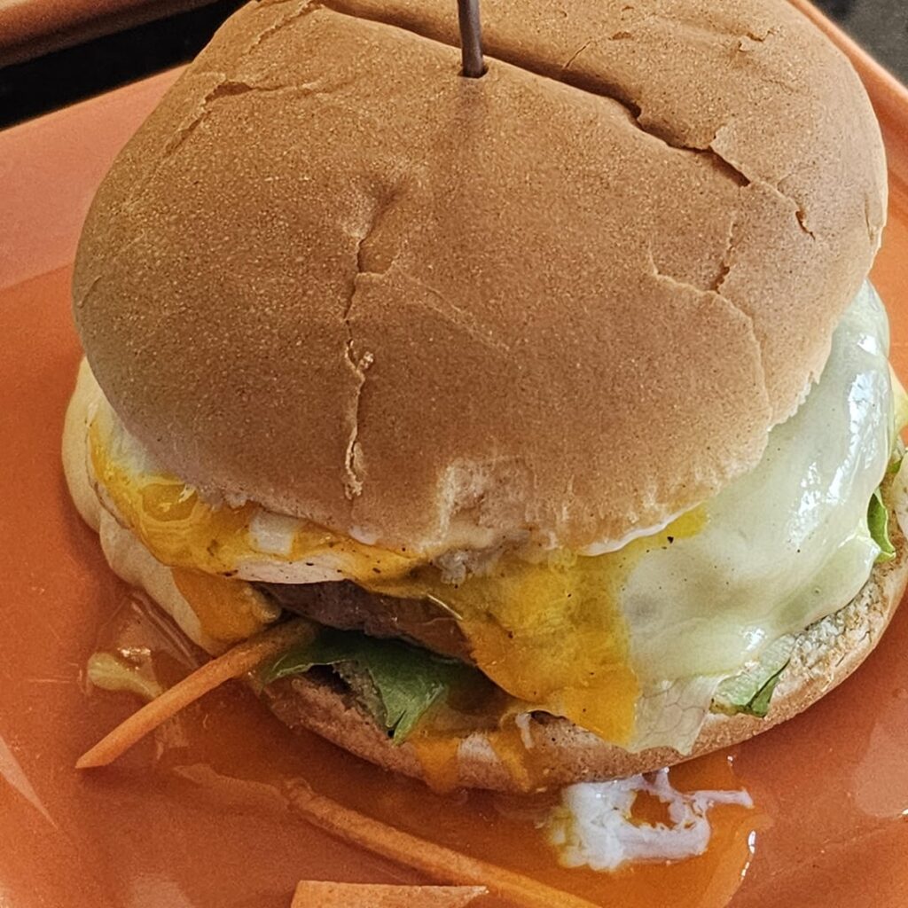 Burger with mixed salad, beef patty, burger sauce, freshly molten raclette cheese, and an egg on it ;)