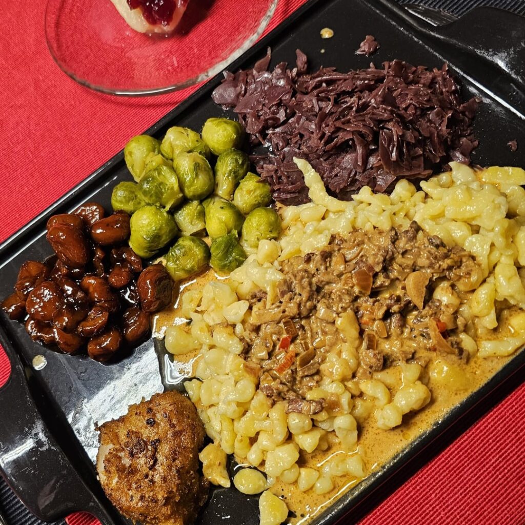 XMas dinner ― Pork fillet medallions with homemade spaetzle, red cabbage, Brussels sprouts, glazed chestnuts, served with a creamy porcini mushroom sauce