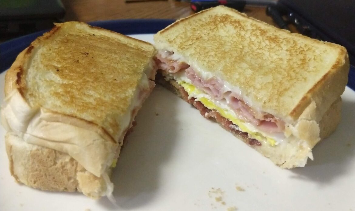 Bacon, ham, egg and pepper jack cheese on buttered Texas toast