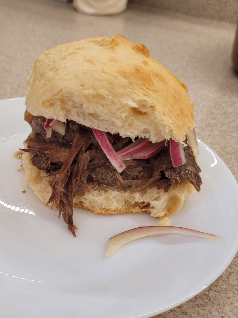 Christmas Eve leftovers sandwich, featuring roast beef, gravy, Hawaiian sweet roll buns, and pickled onions!