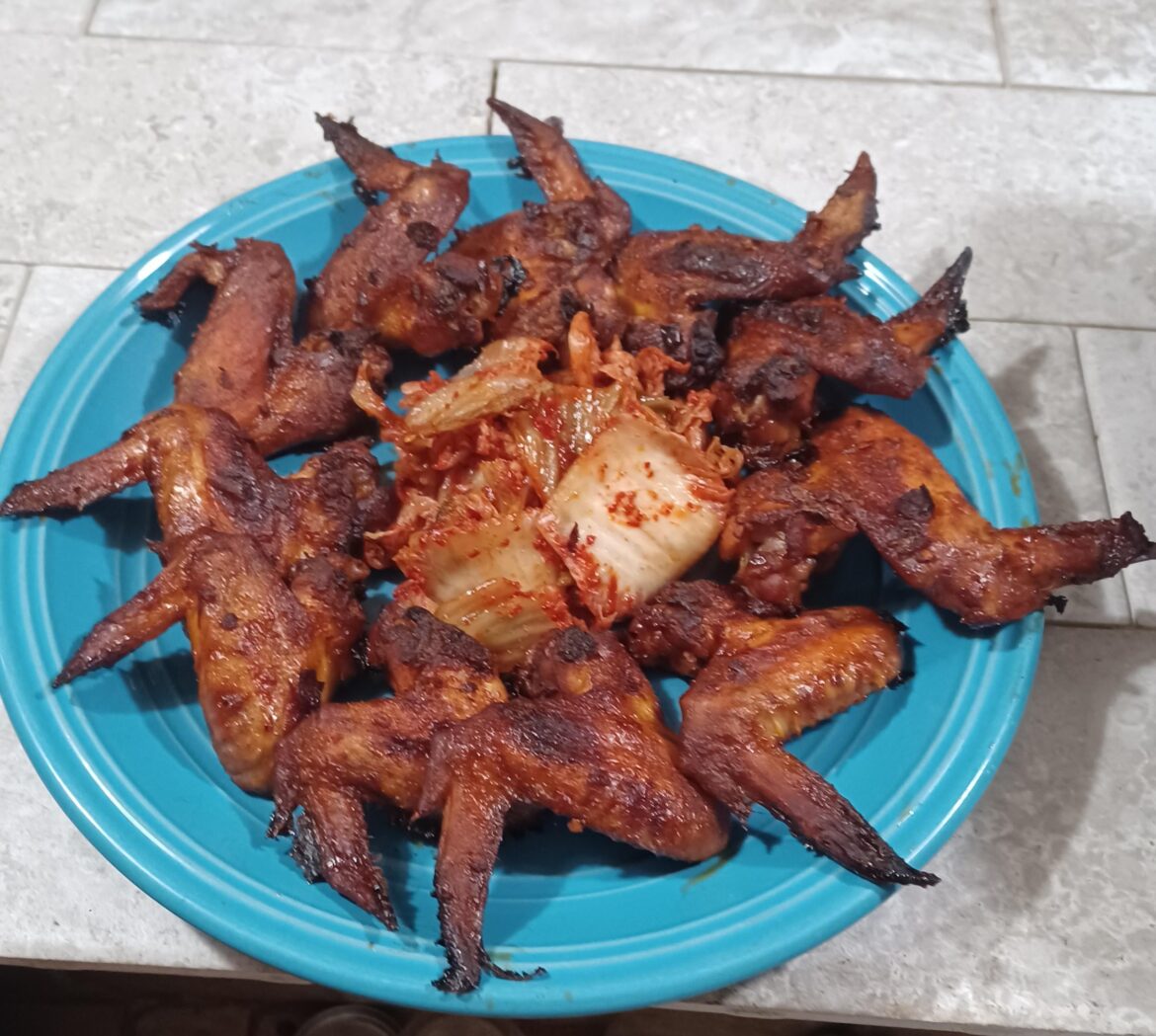 Chili oil and ponzu marinated wings with a side of kimchi