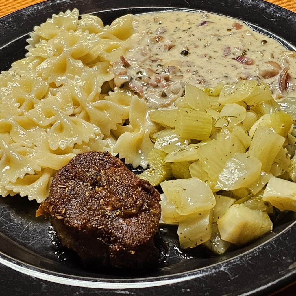 Low-temperature cooked pork tenderloin medallions in a spicy sauce made from whole green peppercorns, cognac, bacon, white wine and onions, served with lemony fennel and farfalle.