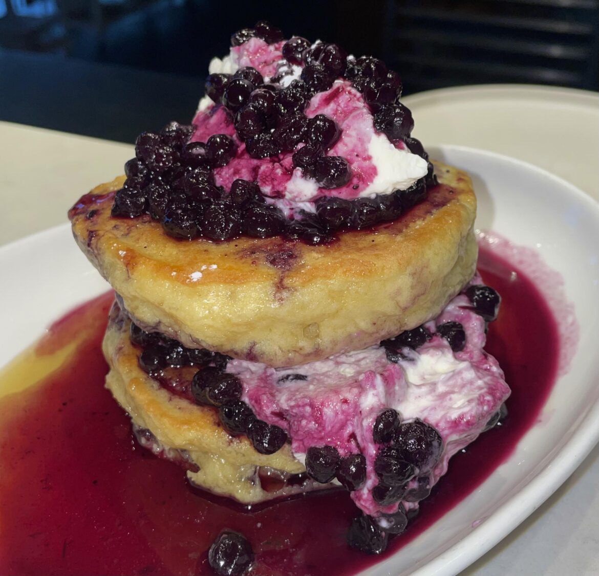 Buttermilk pancakes with maple syrup, whipped cream, and blueberry compote from Mildred’s in Liberty Village.