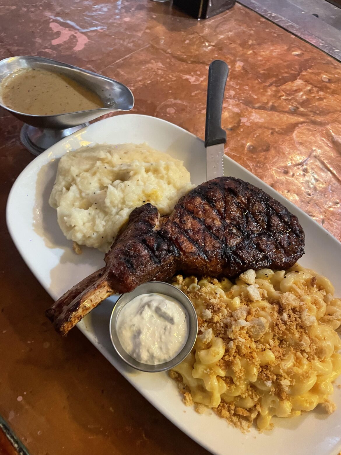Hyde Park Grill - Pork chop with mashed potato and mac and cheese, au jus and horseradish cream hi