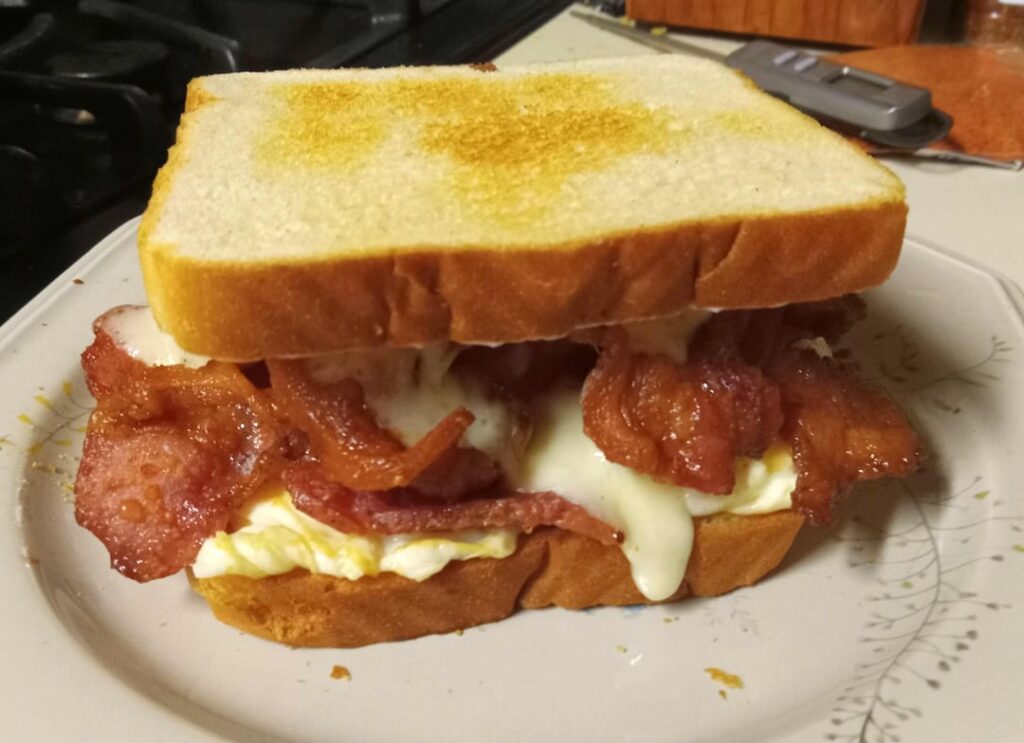 Be Careful - It's a gusher! Over easy eggs, havarti cheese, and extra Bacon on light toast