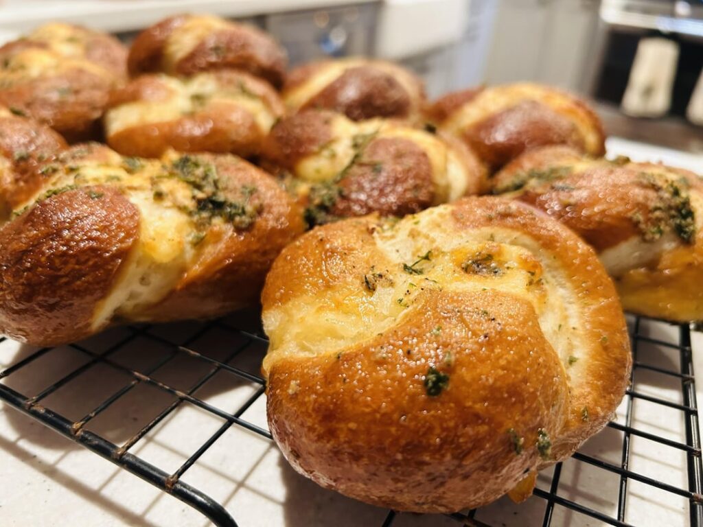 Mozzarella and parmesan stuffed garlic and rosemary pretzel rolls