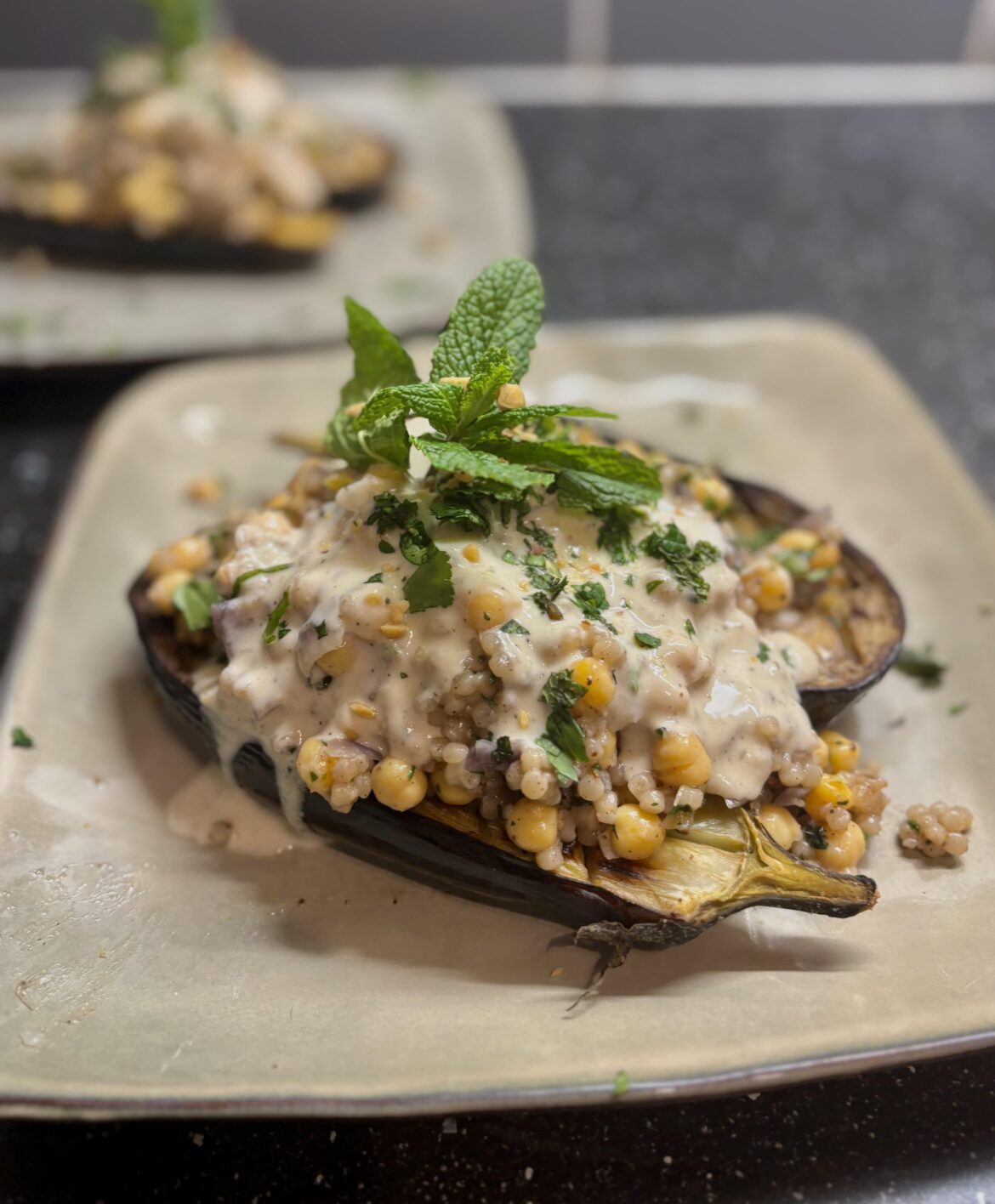 Roasted aubergine with pearl couscous, chickpeas and tahini sauce