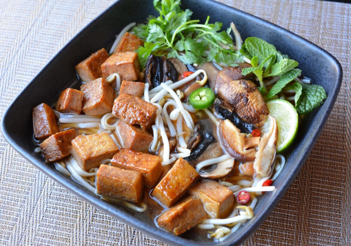 (263 cal, 21 g protein) Pho with hoisin tofu, mung bean sprouts, mushrooms, mint, lime, cilantro, pho broth, and noodles