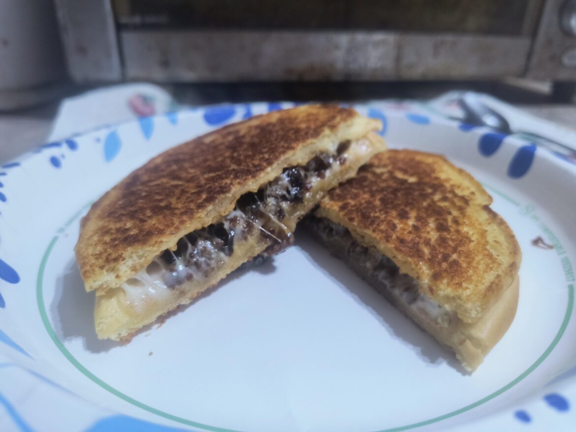 Chopped breakfast sausage, grilled onions and provolone on an inverted burger bun, toasted with butter Chopped breakfast sausage, grilled onions and provolone on an inverted burger bun, toasted with butter