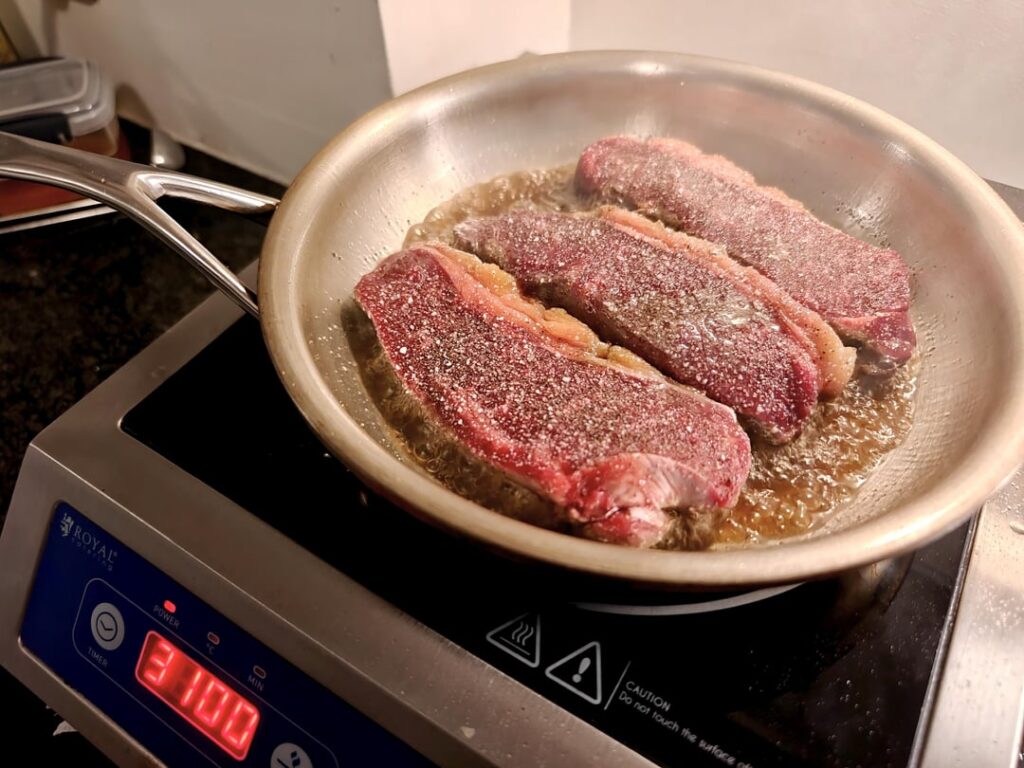 Ghee seared tiny NY strip steaks on induction