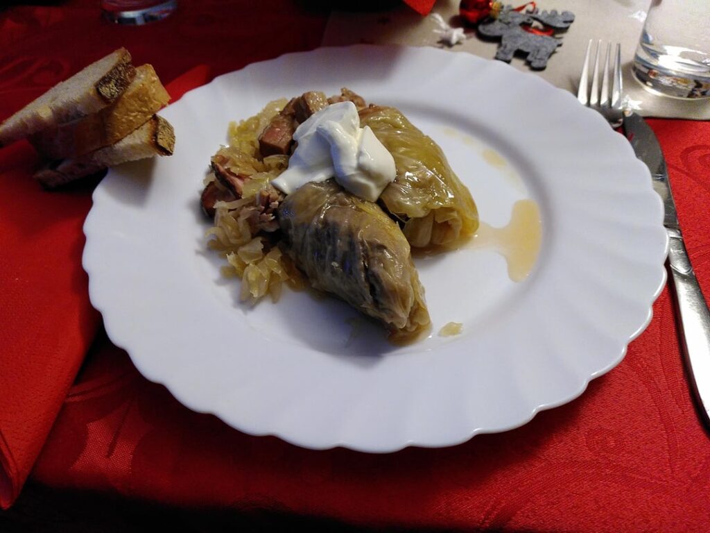 Classic Transylvanian Christmas Eve Dinner: Sour cabbage wraps (filled with minced pork and rice) cooked in homemade sour cabbage and smoked bacon with sour cream, and rolled cakes with poppy seeds and raisins and walnuts respectively