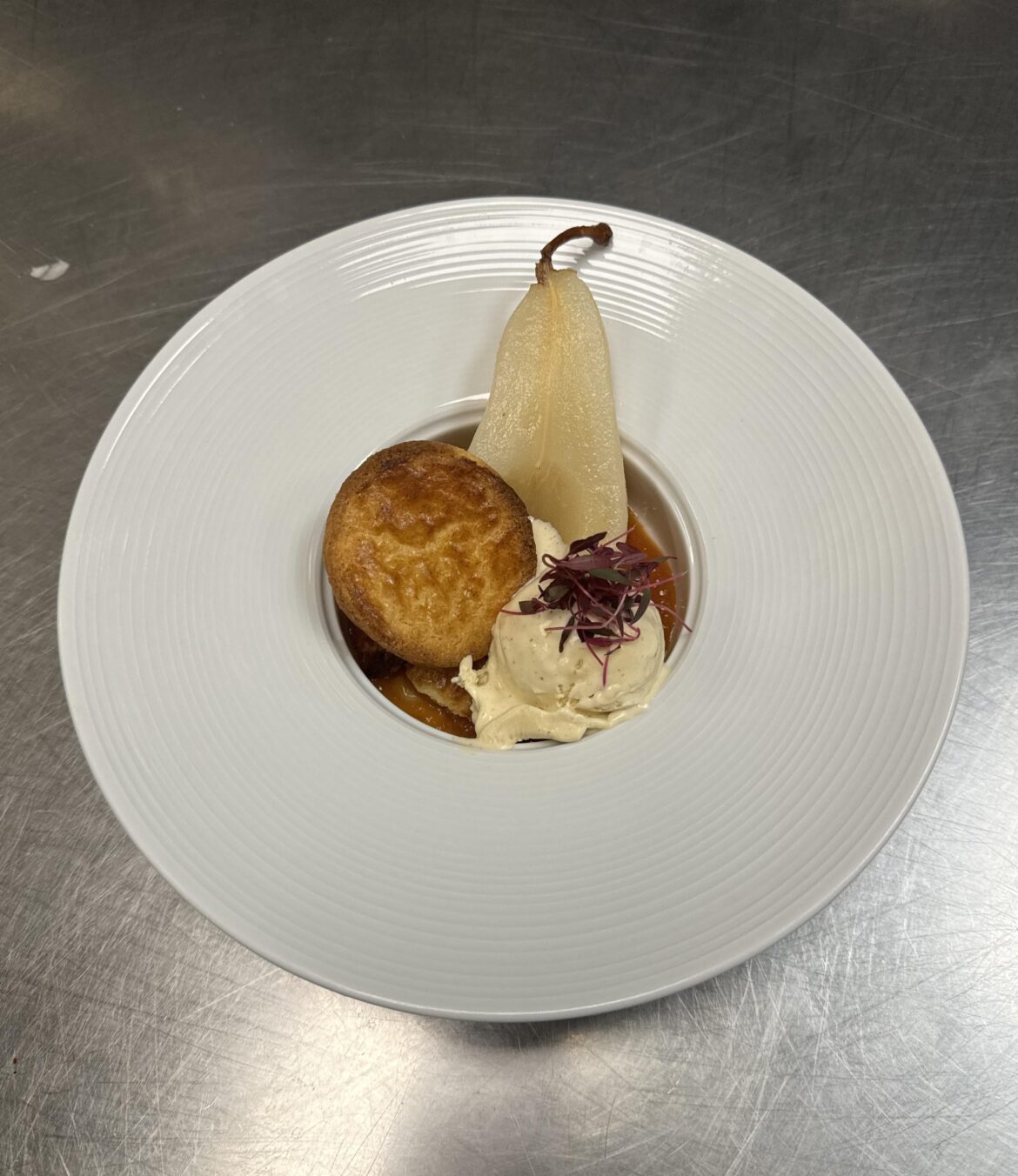 White wine poached pear, quince and orange jam, winter spice ice cream and butter cookie